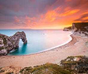 Morze, Skały, Anglia, Zachód słońca, Łuk wapienny, Wybrzeże Jurajskie, Durdle Door, Plaża