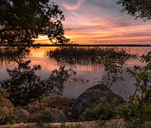 Jezioro, Zachód słońca, Roślinność, Kamienie, Drzewa