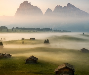 Dolomity, Płaskowyż Seiser Alm, Włochy, Mgła, Domki, Góry Sassolungo, Drzewa, Dolina Val Gardena